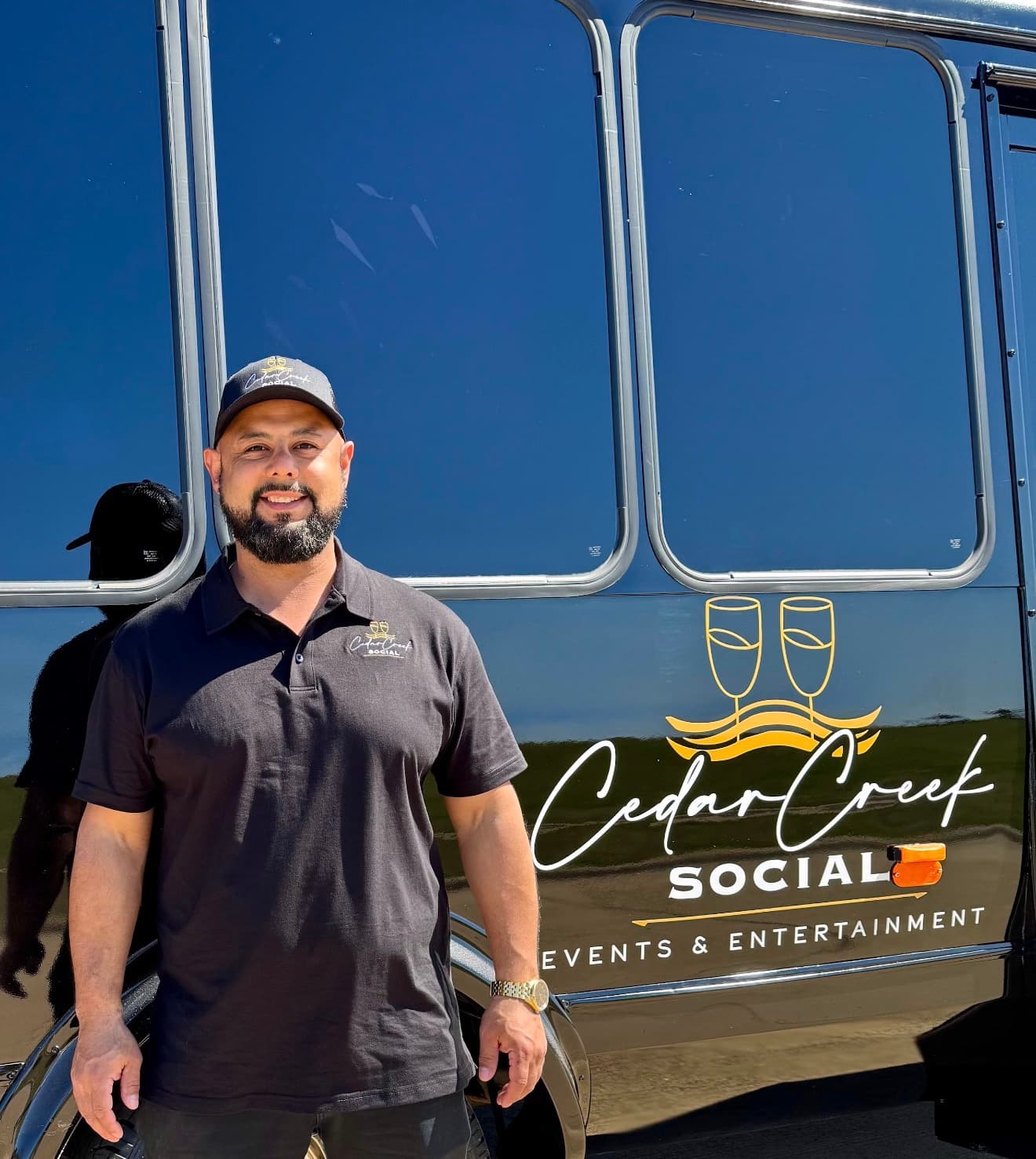 Giovanni Rodríguez, owner of Cedar Creek Social, standing in front of the party bus